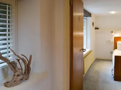 a room with a door with a branch on a wall at Moderno-Uk12748 in Menheniot