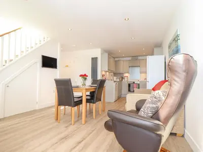 a kitchen and dining room with a table and chairs at The Crest in Helston