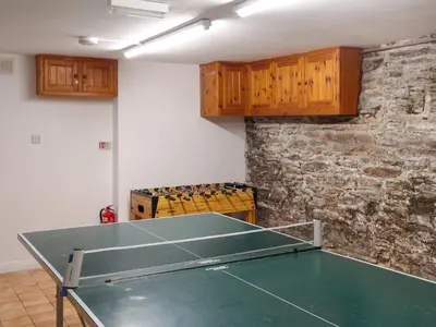 a ping pong table in a room with a ping pong ball at Middle Deck in Fowey
