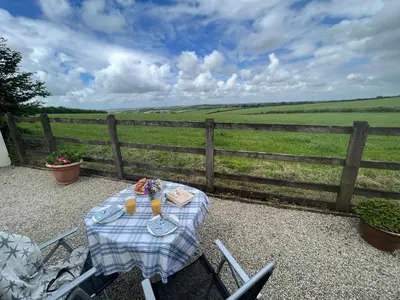 a picnic table with a view of a field at Palmers Lodge in Launceston