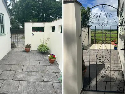a gate to a garden with potted plants on a patio at Palmers Lodge in Launceston