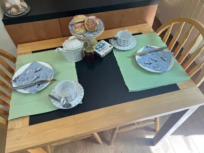 a wooden table with plates and dishes on it at Palmers Lodge in Launceston