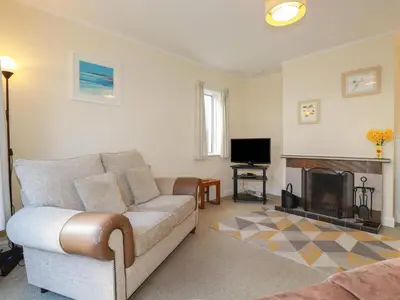 a living room with a couch and a fireplace at 5 Carlyon Road in Truro