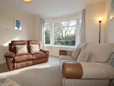 a living room with a couch and a chair at 5 Carlyon Road in Truro