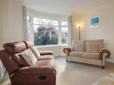 a living room with a couch and a chair at 5 Carlyon Road in Truro
