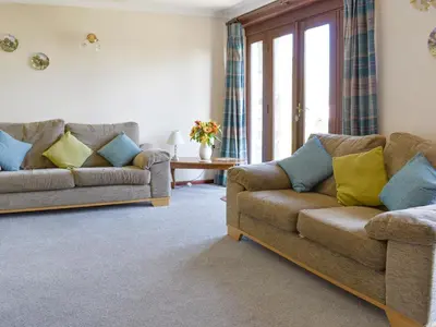 a living room with two couches and a table at Haywain - Uk12084 in Saint Endellion