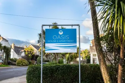 a sign for anolis house and beach night at Oasis Apartment in Falmouth