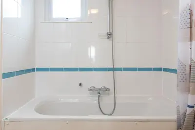 a shower in a bathroom with a bath tub at Waves Apartment, St Ives in St Ives