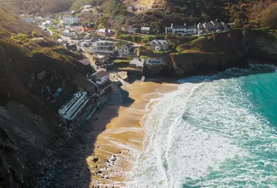 an aerial view of a beach with houses and the ocean at Amaroo in St. Agnes