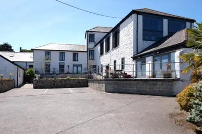 a large white house with a large balcony at Copperhouse View in Hayle