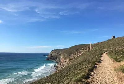 a path leading down a hill to the ocean at The Shires in St. Agnes