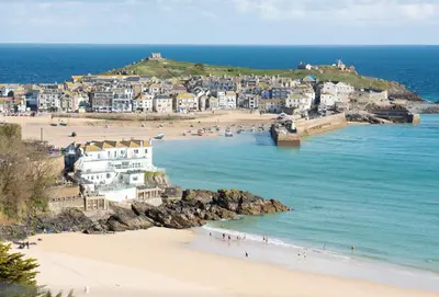 a group of people on a beach near the ocean at The View in Carbis Bay