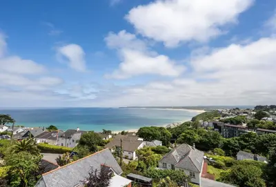 a view of a coastal town with houses and the ocean at The View in Carbis Bay