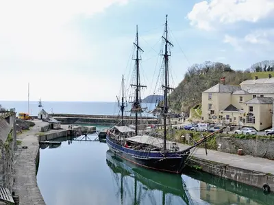 a boat is docked in the water in a harbor at Millys Nook in St Austell
