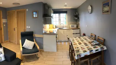a kitchen and dining room with a table and chairs at 41 Tudor Court in Hayle