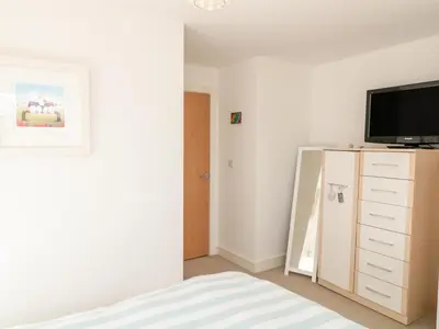 a bedroom with a bed and a tv on a dresser at Ripple in Bodmin