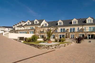 a large brick building with a lot of windows at APARTMENT BY THE BEACH The Foxcove in St Merryn