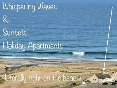 a poster of the beach with the wordswrecking waves and sunsetholiday appliances literally at Sunsets In Porthtowan, Beachfront apartment in Porthtowan