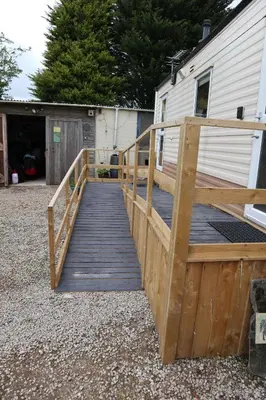 a wooden ramp leading to a building with a house at Kimberley Lane Static, Cornwall in Gwennap