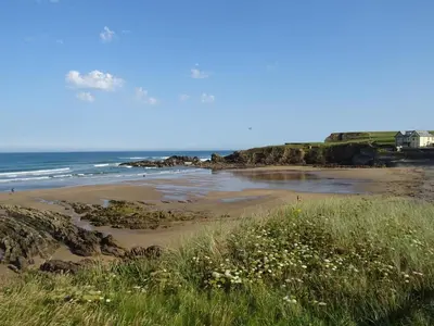 a sandy beach with the ocean in the background at Penfound Country Cottage in Poundstock
