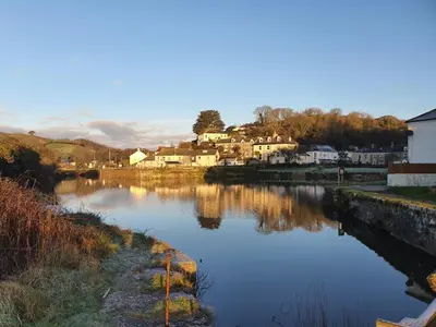a view of a river with houses and buildings at Lime Kiln Cottage, Pentewan, Cornwall in Pentewan