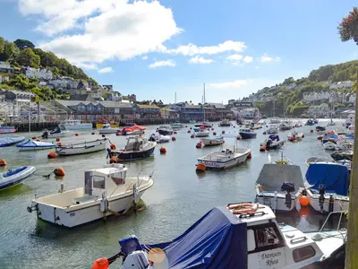 a bunch of boats are docked in a harbor at Laity in Polperro