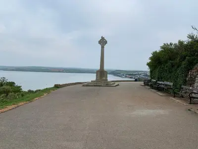 a monument with benches on the side of a lake at The Padstow Cottage - Coswarth House in Padstow