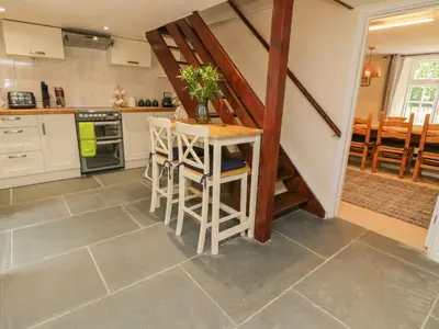 a kitchen with a table and chairs in a room at 9 Copes Gardens in Truro