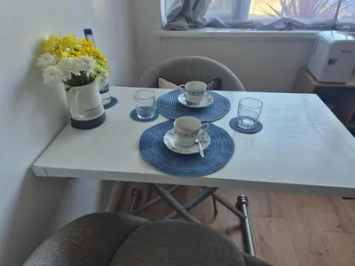 a table with plates and cups and glasses on it at Number 6 in St Austell