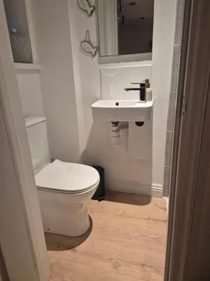 a bathroom with a white toilet and a sink at Number 6 in St Austell