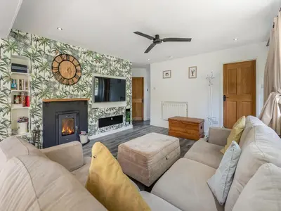 a living room with a couch and a fireplace at By The Beach- Uk31201 in Downderry