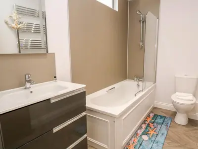 a bathroom with a tub and a sink and a toilet at Atlantic View in Penzance