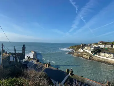 a view of the ocean from a city with people walking on the stairs at Pen Chy in Helston