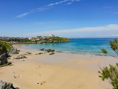 a group of people on a beach near the ocean at Fistral Bay Cottage in Newquay