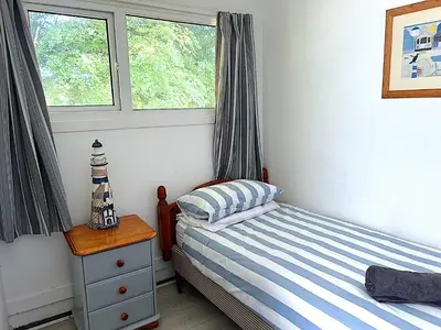 a small bedroom with a bed and a window at Holiday home, Camelford, Cornwall in Camelford