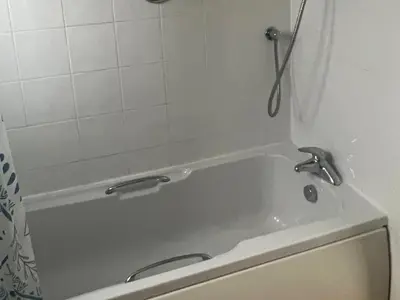 a bath tub in a bathroom with a shower at Holiday home, Camelford, Cornwall in Camelford