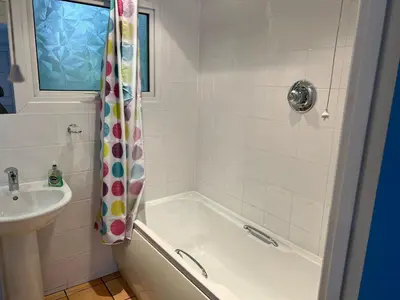 a white bathroom with a tub and a sink at Holiday home, Camelford, Cornwall in Camelford