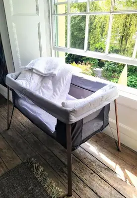 a bed in a room next to a window at The Shire House in Lostwithiel