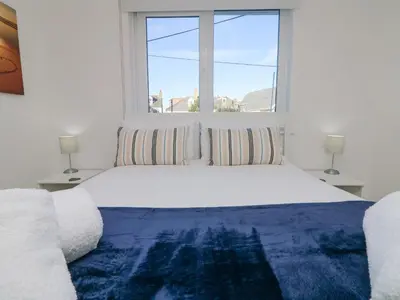 a bedroom with a large bed with a window at The Beach Hut in St Ives