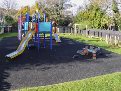 a playground with a slide in a park at Miles Retreat in Hayle