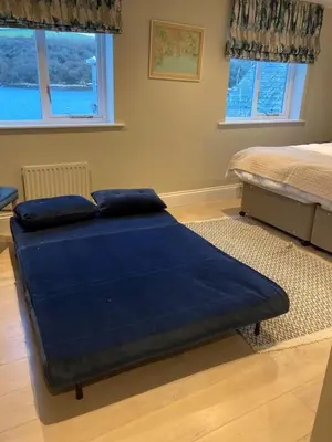 a bedroom with a bed with a blue blanket at The Galleon Inn in Fowey