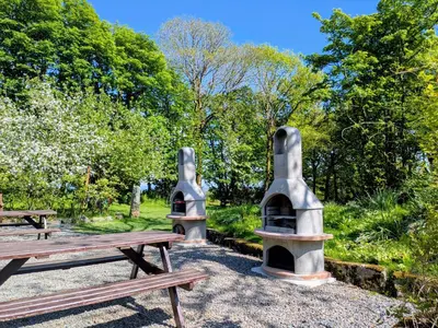 two picnic tables and benches in a park at The Roundhouse in Launceston
