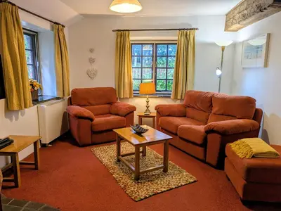 a living room with two couches and a table at The Roundhouse in Launceston