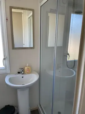 a bathroom with a sink and a shower at Newquay Bay Resort - SummerBreeze PV54 in Porth