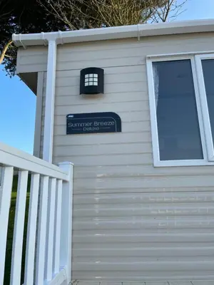 a garage door with a sign on it at Newquay Bay Resort - SummerBreeze PV54 in Porth
