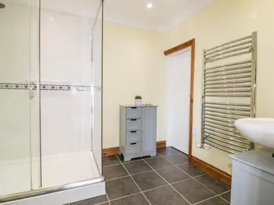 a bathroom with a shower and a sink at Lower Brambleside in Truro