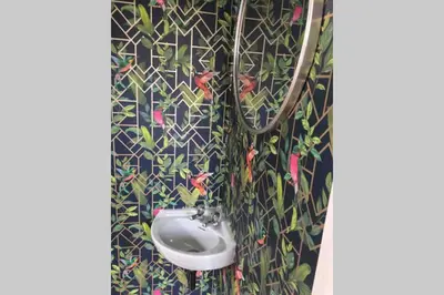 a bathroom with a white sink in a wall at Lovely 3 Bed House Close to Carlyon Bay Beach! in Carlyon Bay