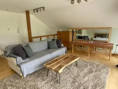 a living room with a couch and a table at Little Chi in Truro