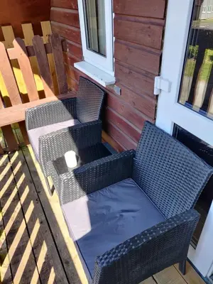 two wicker chairs and a table on a porch at Blissful Escape Hengar Manor in Bodmin