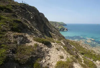 a view of the ocean from the side of a mountain at Salty's Cottage in St. Agnes